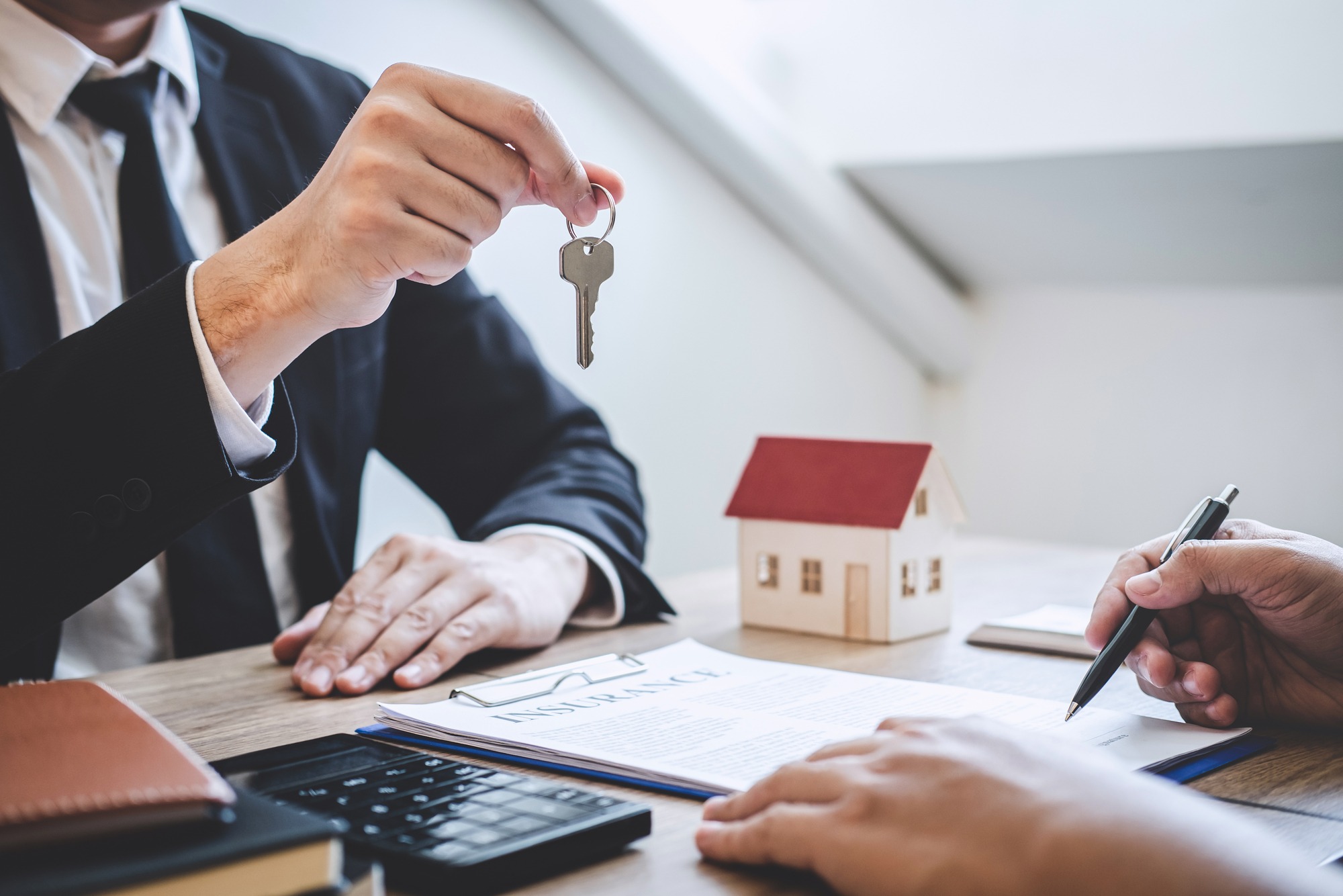 Estate agent giving house keys to client